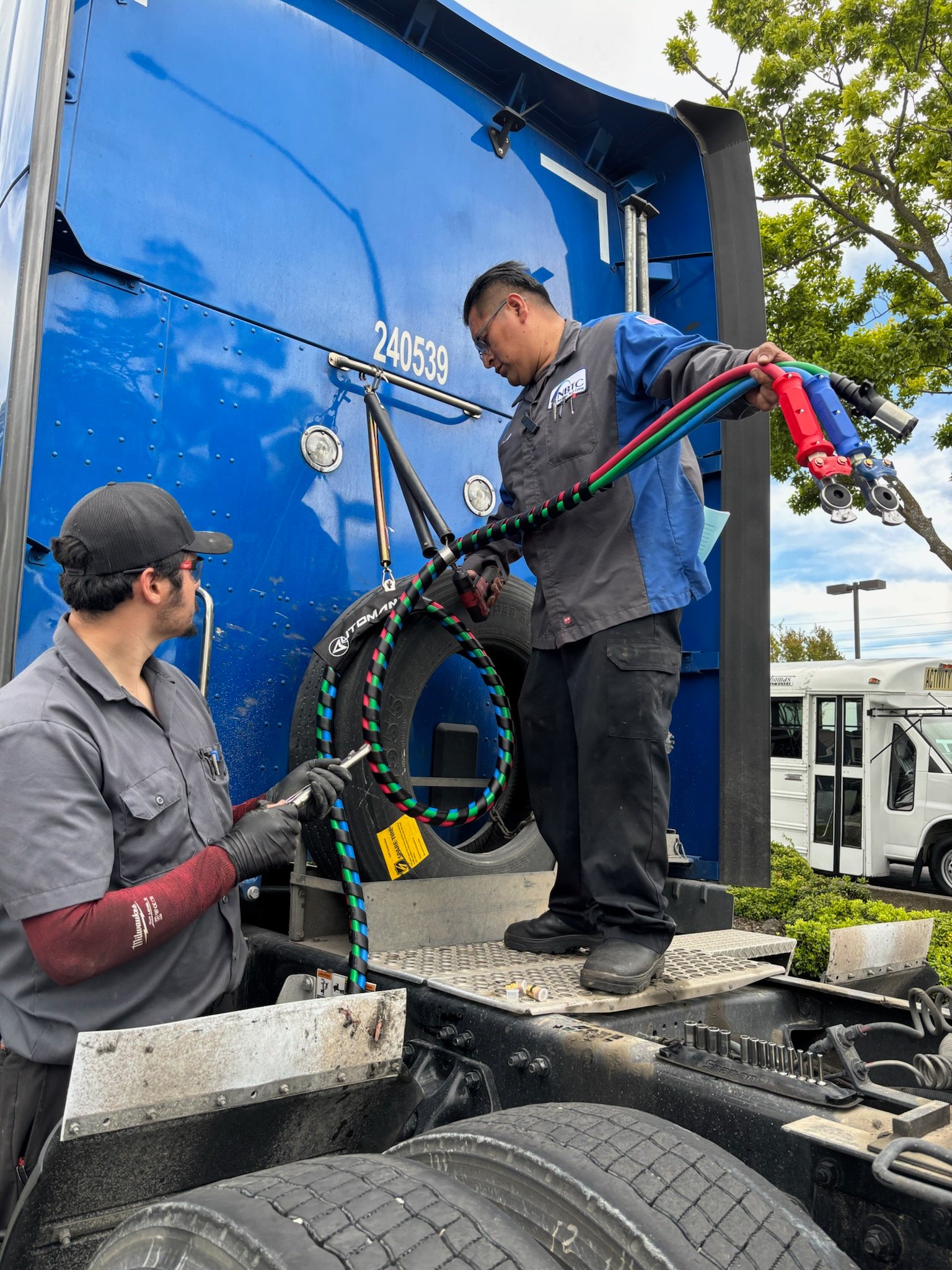 Mechanics working on a truck in the bay